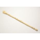 A carved ivory backscratcher