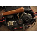 A cased Canon EOS 600 camera plus a Sigma lens and flash gun