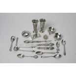 A bag containing mixed silver items including a pair of vases, salts,