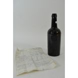 An antique unsealed wine bottle from the Bristol glass works displaying the crest of the Wyndham