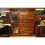 A Quality Maple & Co Edwardian walnut compactum wardrobe fitted with a single mirrored door,