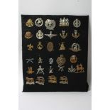 A collection of 25 cap badges including some retrospective copies, including Hertfordshire Regiment,