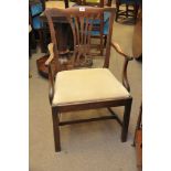 A late George III mahogany  open arm chair with square legs united by stretches