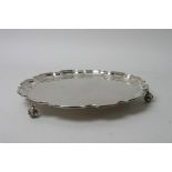 A silver salver with scalloped edge,