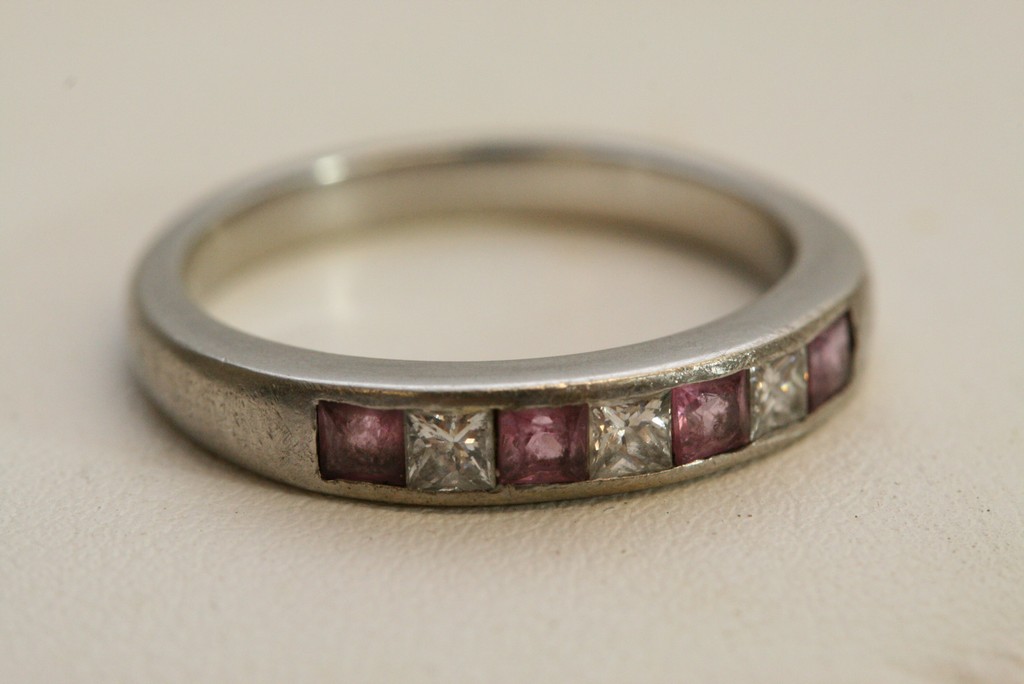 An unmarked platinum ring inset with diamonds and amethyst