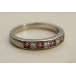 An unmarked platinum ring inset with diamonds and amethyst