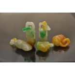 A collection of five multi colour jade good luck charms