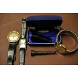 A silver cigar cutter and three gent's wristwatches