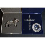 A boxed Swarovski lioness and an ornamental cross