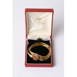 A fine 18ct gold bracelet with ruby inset and seven separate sapphires