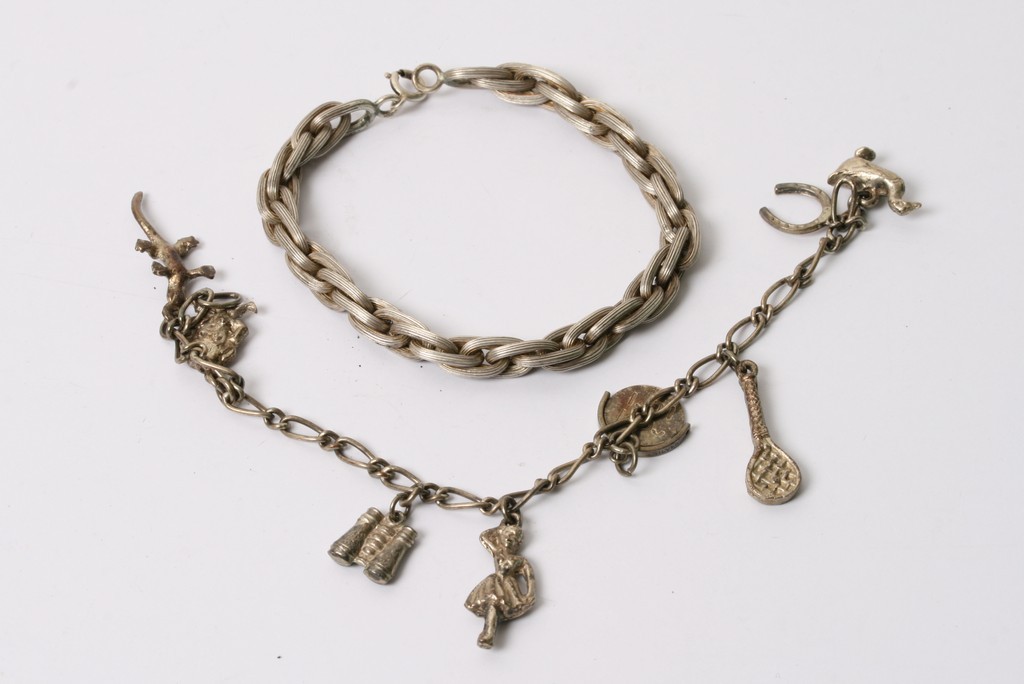 A white metal bracelet stamped 850 and a silver charm bracelet (2)