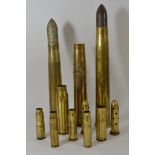 Three large brass shell cases (one R.A.