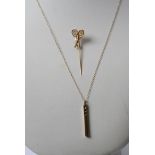 A 9ct gold and diamond pendant with a gold chain and a stick pin in the form of tennis rackets