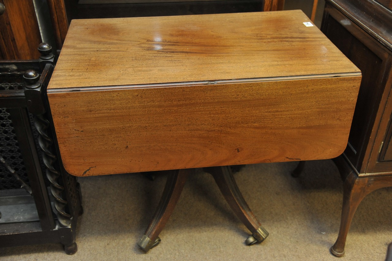 A 19th century mahogany breakfast table with twin flaps on a pedestal and four splayed legs