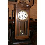 A mahogany cased wall clock with silvered dial.