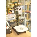 A set of cast iron shop scales with a porcelain tray