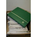 A box containing a collection of Great Britain First Day Covers and a stock book of stamps