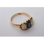 An 18ct gold ring set with large sapphire and two opals with four small diamonds.