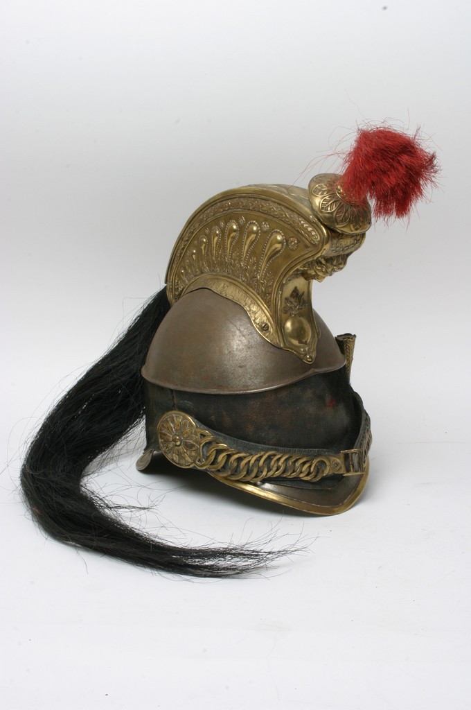 A 19th Century French cavalry helmet with red plume and leather mount