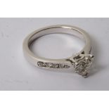 An 18ct white gold ring inset with heart shape diamond, 1.00ct S12/H+ diamond shoulders 0.