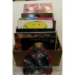 A box containing a collection of LP records including King Crimson, Colosseum, Lou Reed, Queen,