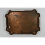 An Arts and Crafts hammered copper tray with Masonic decoration and shaped edges,