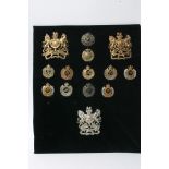 A collection of 11 different Royal Engineers cap badges and three helmet plates,