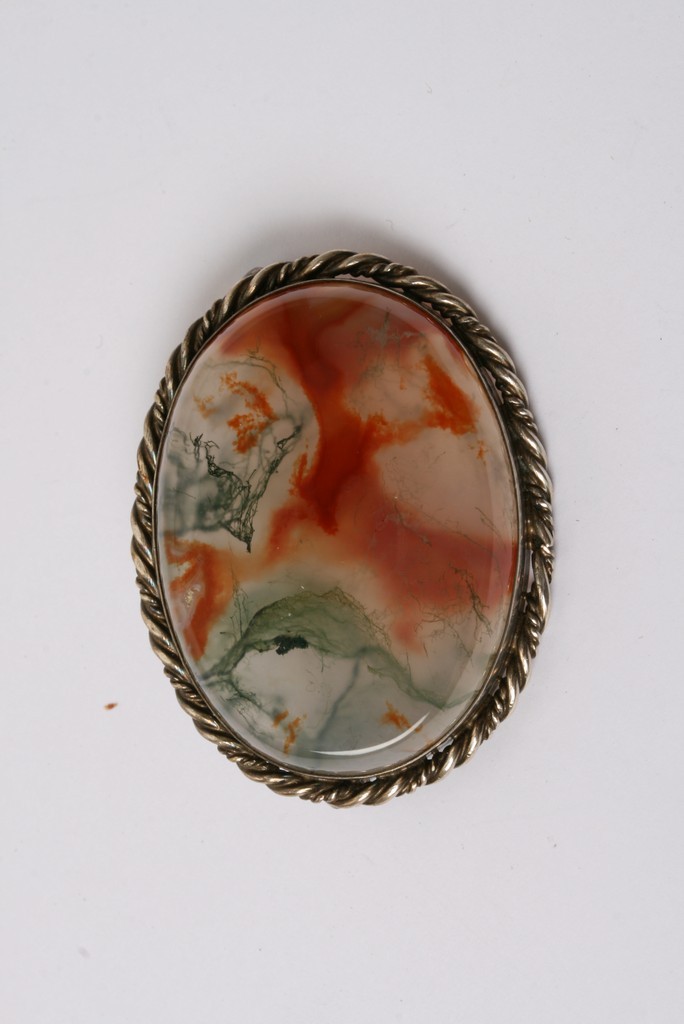 A moss agate brooch of oval shape