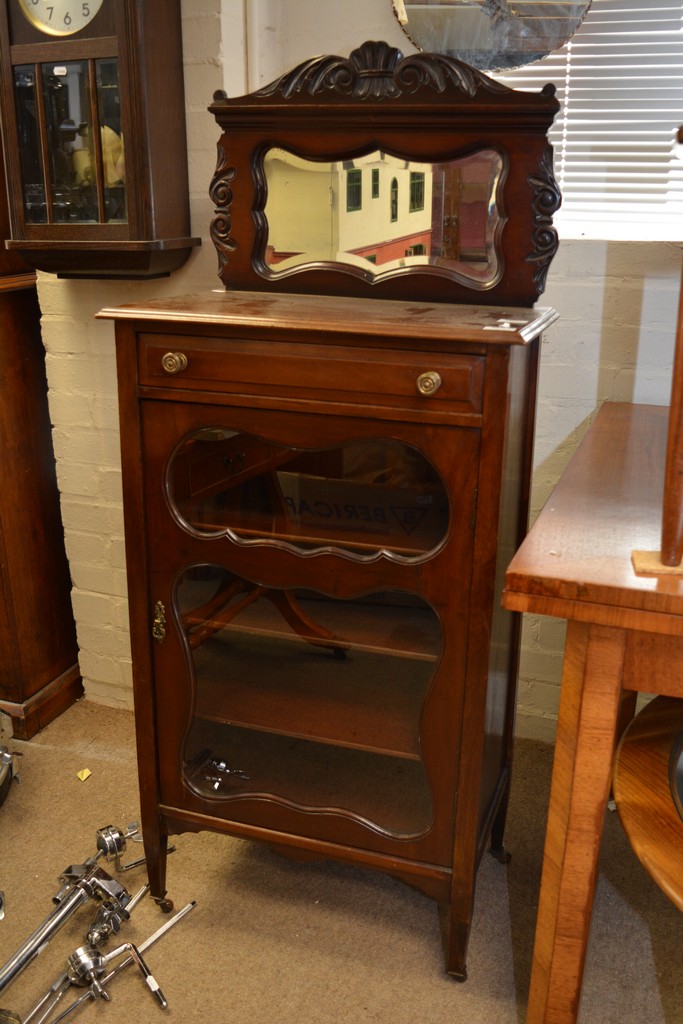 A mahogany Edwardian mirrored back music cabinet