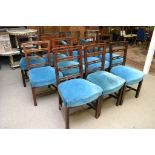 A set of eleven George III mahogany ladder back dining chairs with blue upholstered stuffover seats