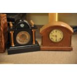 A metal mantel clock and an oak case clock