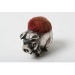 A miniature silver pin cushion formed as a pig,