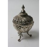 An attractive silver lidded pot on tripod feet finished with bow swags and repeated swirl