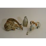 Three Russian ceramic figures comprising a Lomonosov giraffe and a penguin plus a dog (possibly