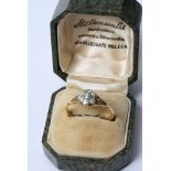 An 18ct gold and platinum ring set with diamonds in the form of a flower in a fitted box