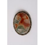 A moss agate brooch of oval shape