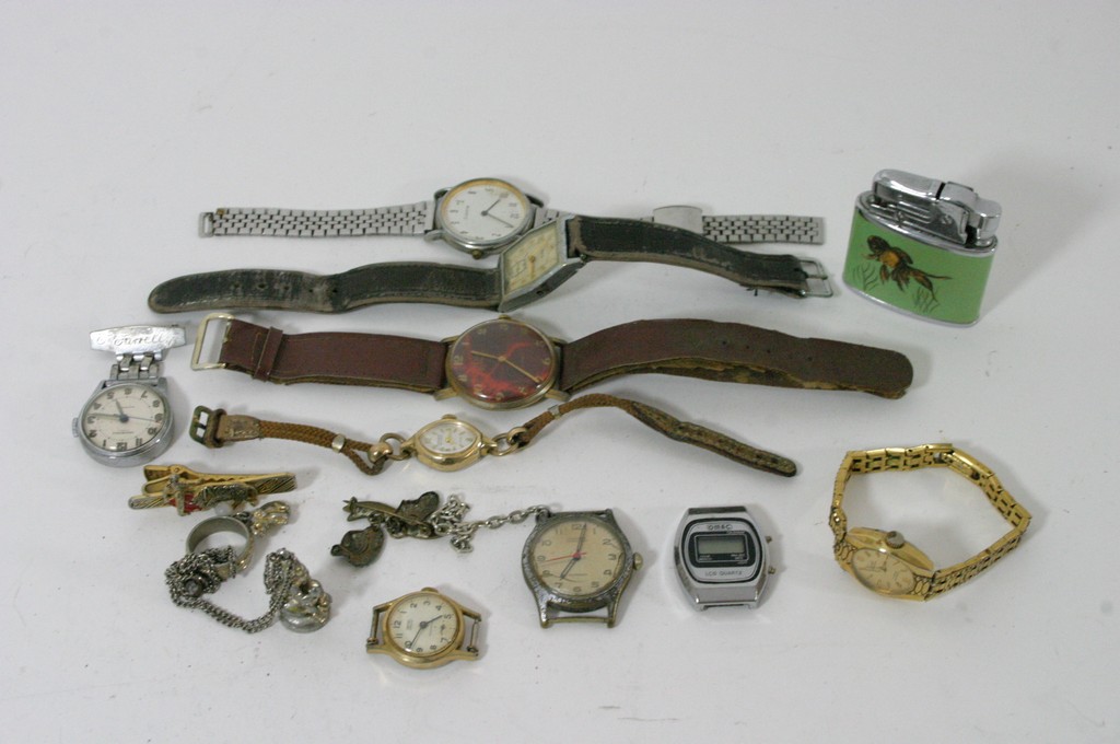 A bag containing various wrist watches and a cigarette lighter