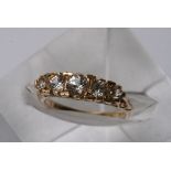 A 9ct gold ring inset with five graduating CZ