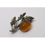 A silver and amber leaf shaped brooch