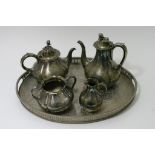 A silver plated galleried tray and four piece tea set.