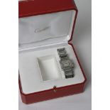 A Cartier tank stainless steel watch in box in working order