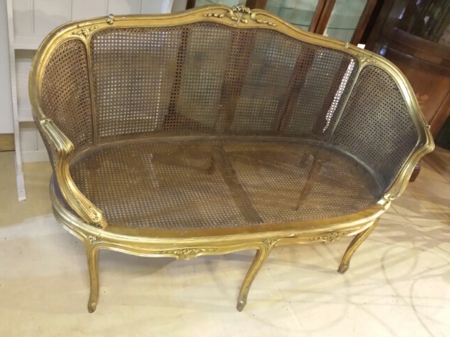 19th century French carved giltwood settee with caned panels. 138 cm wide