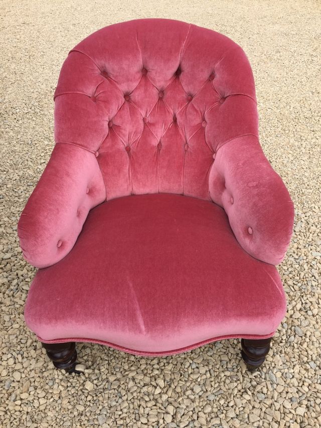 Victorian nursing chair in pink upholstery, button backed on turned supports and original castors.