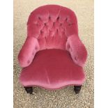 Victorian nursing chair in pink upholstery, button backed on turned supports and original castors.