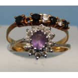 A 9ct gold ring set with a purple stone