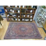 A blue & red ground Persian rug with sty