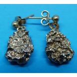 A pair of earrings fashioned as gold nug
