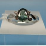 A white metal ring set with Alexandrite