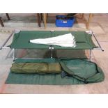 Three various folding camp beds and a pa