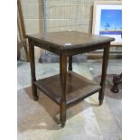 A small square occasional table with she
